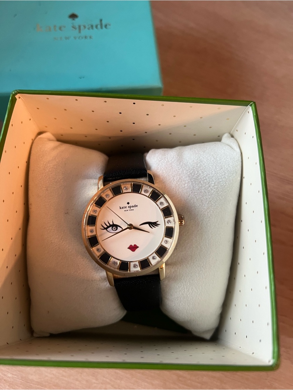 kate spade Gold Tone Winking Face Watch with Black Strap